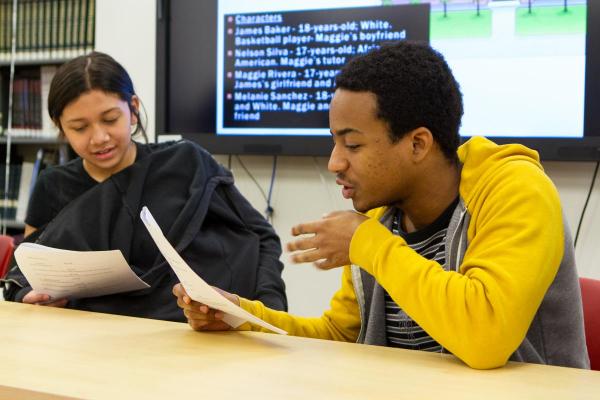 Two students reading through dialogue in a script