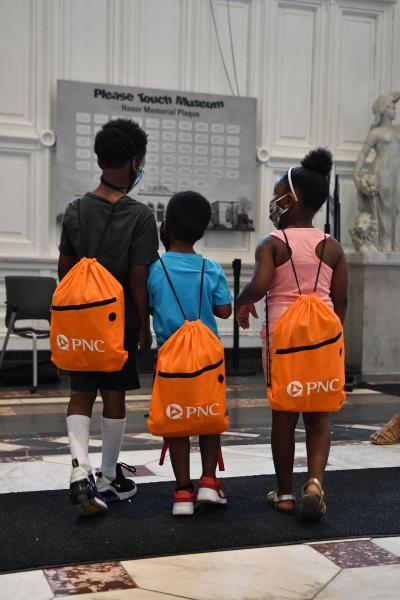 Three young Black children with backpacks from Summer Discovery Backpacks