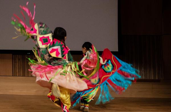 We Are the Seeds Dance Troupe featuring two children in traditional costume on stage at PAFAs auditorium