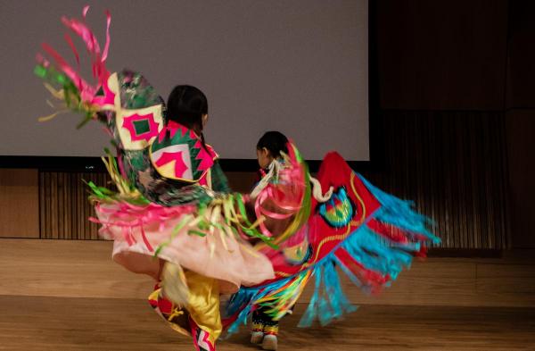 We Are the Seeds Dance Troupe featuring two children in traditional costume on stage at PAFAs auditorium